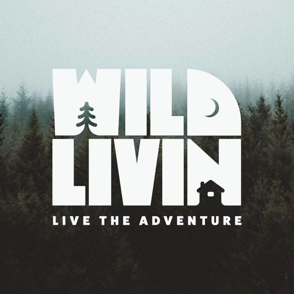 Wild Livin badge — lettering over a misty pine forest